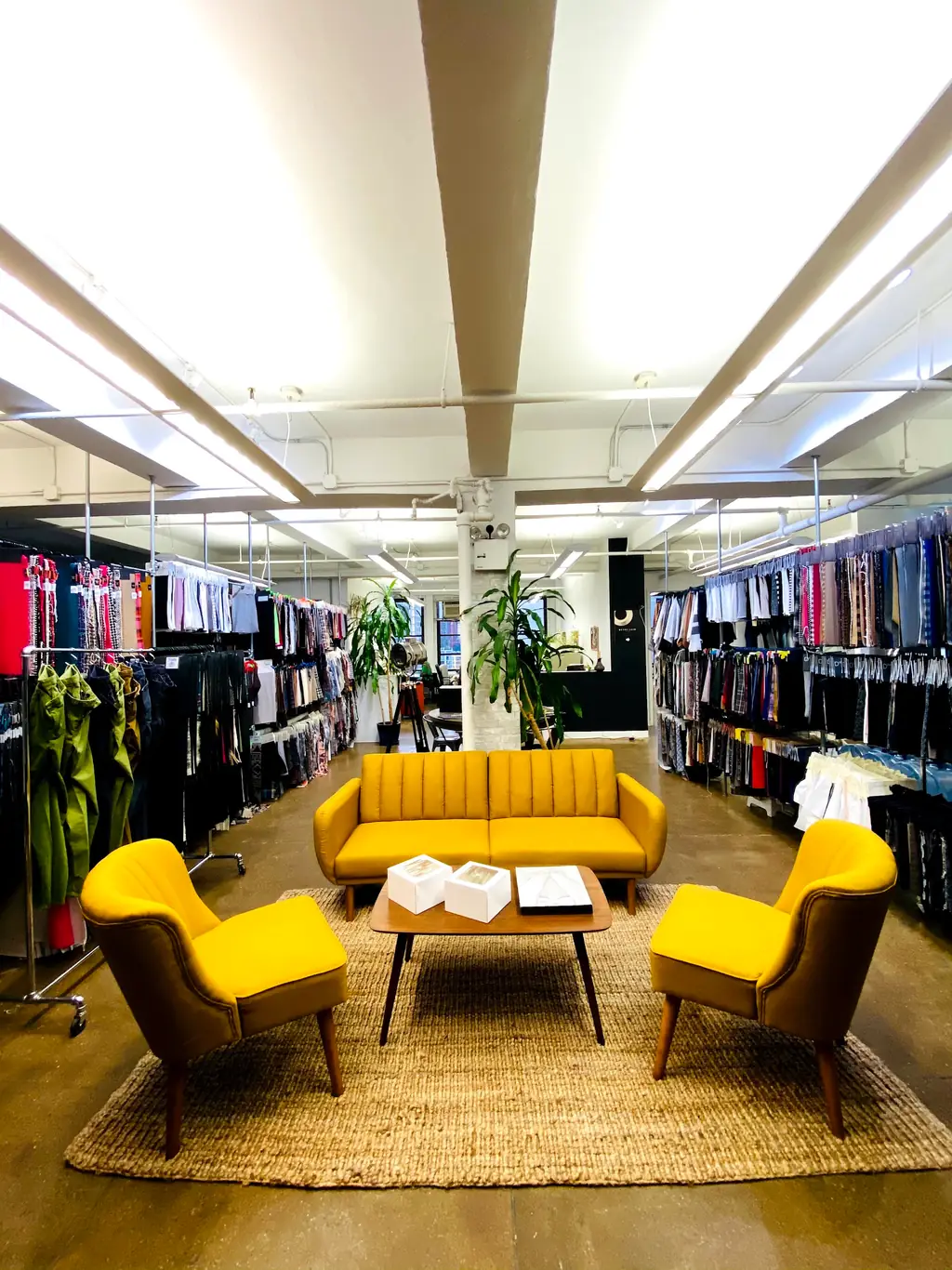 Fabric hanger racks lining both walls of the West 39th Street showroom